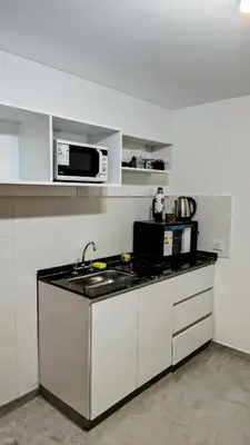 a kitchen with a sink and a microwave at Patio Olmos a pasos in Cordoba