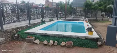 a swimming pool in a yard with a fence at DPTO ZONA centro in Villa Carlos Paz