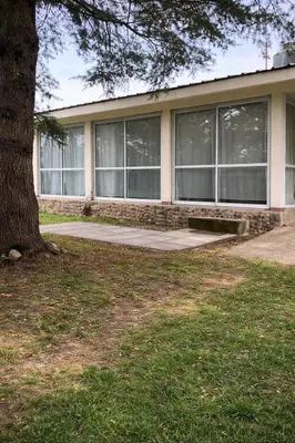 a house with a tree in front of it at El Bosque de Simba - Casa in La Estancia