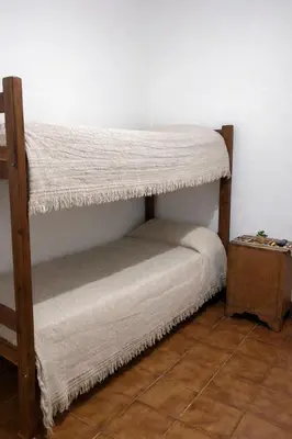a room with two bunk beds in a room at El Bosque de Simba - Casa in La Estancia