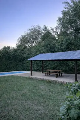 a picnic shelter with a bench in a park at El Bosque de Simba - Casa in La Estancia