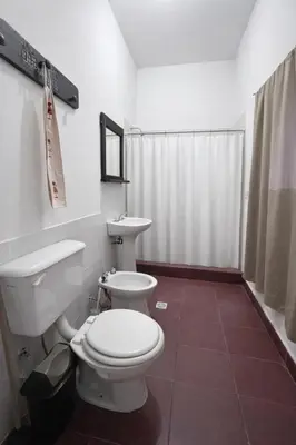 a bathroom with a white toilet and a sink at El Bosque de Simba - Casa in La Estancia