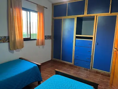 a bedroom with two beds and a closet at La Soñada San Antonio de Arredondo in San Antonio de Arredondo
