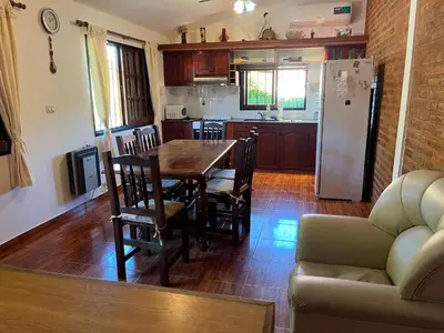 a kitchen and dining room with a table and a refrigerator at La Soñada San Antonio de Arredondo in San Antonio de Arredondo
