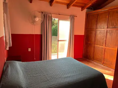 a bedroom with a blue bed and a window at La Soñada San Antonio de Arredondo in San Antonio de Arredondo