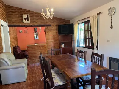 a dining room with a wooden table and chairs at La Soñada San Antonio de Arredondo in San Antonio de Arredondo