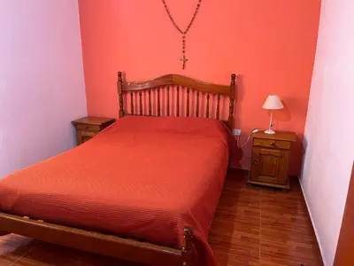 a small bedroom with a bed and a night stand at La Soñada San Antonio de Arredondo in San Antonio de Arredondo