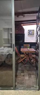 a room with a table and a bench in a room at Depto Bodhi Dorado in Villa Carlos Paz