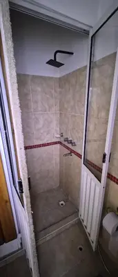 a bathroom with a shower with a glass door at Depto Bodhi Dorado in Villa Carlos Paz