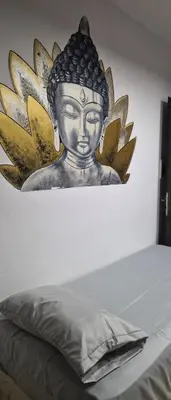 a painting of a buddha on a wall at Depto Bodhi Dorado in Villa Carlos Paz