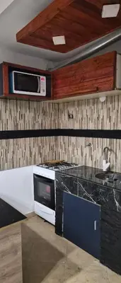 a kitchen with a microwave and a counter top at Depto Bodhi Dorado in Villa Carlos Paz