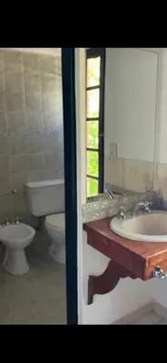 a bathroom with a tub and a sink and a toilet at Hosteria Abuelo Juan in Mina Clavero