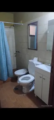 a bathroom with a toilet and a sink and a mirror at La Bonita, casa en Villa de Merlo, SL in Merlo