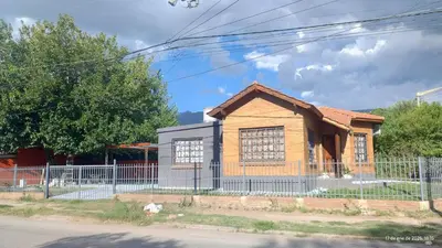 a small house with a fence in front of it at La Bonita, casa en Villa de Merlo, SL in Merlo