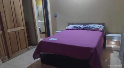 a bedroom with a purple bed with a purple blanket at La Bonita, casa en Villa de Merlo, SL in Merlo