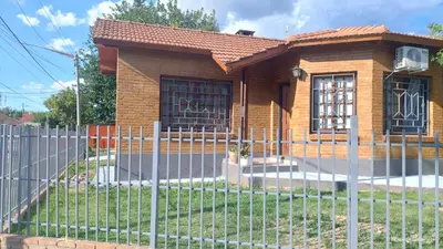 a small house with a fence in front of it at La Bonita, casa en Villa de Merlo, SL in Merlo