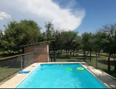 a large swimming pool in a yard with trees at Cabañas Antillanca in Luyaba