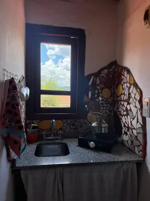 a kitchen counter with a sink and a window at Casa de iris in Mina Clavero