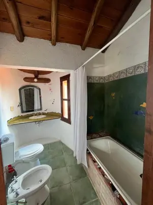 a bathroom with a tub and a toilet and a sink at Casa de iris in Mina Clavero