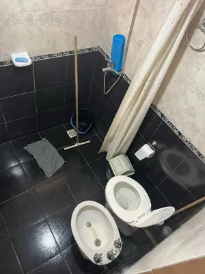 a bathroom with a toilet and a sink at Deptos Mabelita in Mina Clavero