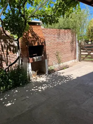 a brick oven in the side of a brick wall at Deptos Mabelita in Mina Clavero