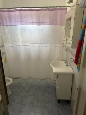 a bathroom with a sink and a shower curtain at Casa en Villa Carlos Paz in Estancia Vieja