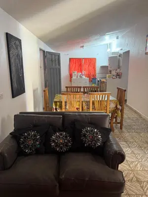 a living room with a couch and a dining room at Casa en Villa Carlos Paz in Estancia Vieja