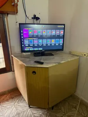 a television on a wooden stand in a room at Casa en Villa Carlos Paz in Estancia Vieja