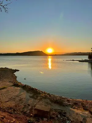 a sunset over a large body of water at Casa del lago in Embalse