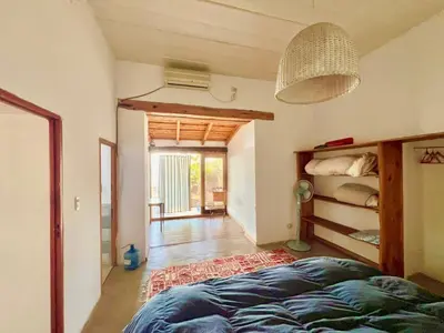 a bedroom with a bed and a room with a hallway at Casa del lago in Embalse