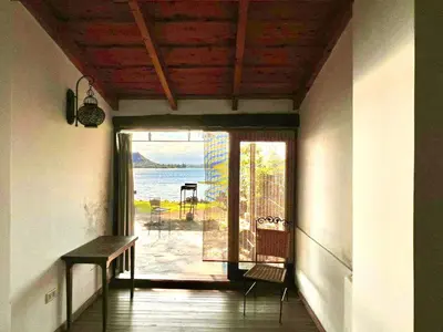 a room with a door to a balcony with a view of the ocean at Casa del lago in Embalse