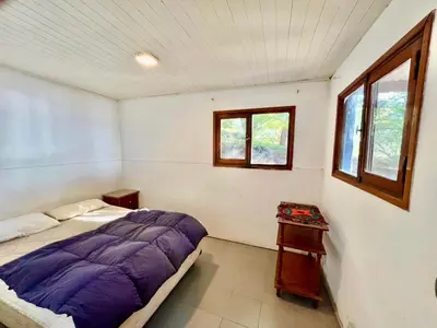 a bedroom with a bed and a window at Casa del lago in Embalse