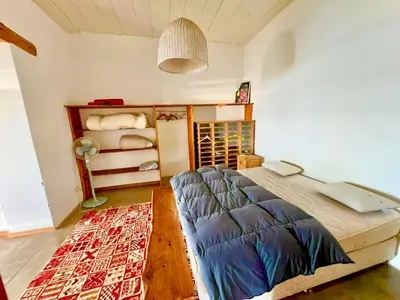 a bedroom with a bed with a laptop on it at Casa del lago in Embalse