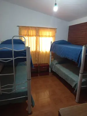 a bedroom with two bunk beds and a window at Casa Agüero in Villa Cura Brochero