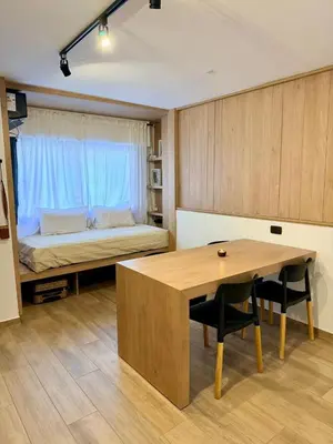 a room with a desk and a bed with a table at Apartment in Nueva Cba meters from Buen Pastor in Cordoba