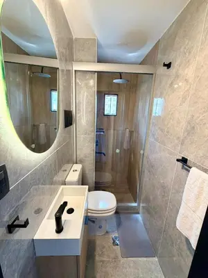 a bathroom with a toilet and a sink and a mirror at Apartment in Nueva Cba meters from Buen Pastor in Cordoba