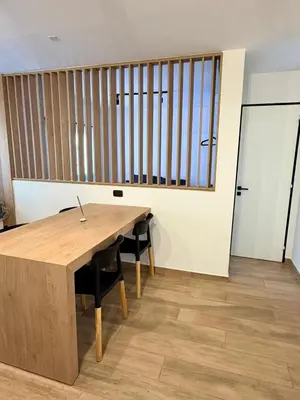 a wooden table and chairs in a room with a window at Apartment in Nueva Cba meters from Buen Pastor in Cordoba