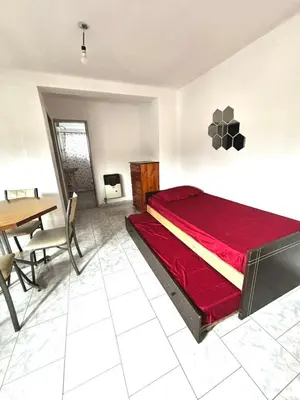 a bedroom with a bed and a dining room table at alojamiento centrico vcp in Villa Carlos Paz