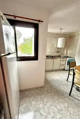 a kitchen with a refrigerator and a window in it at alojamiento centrico vcp in Villa Carlos Paz