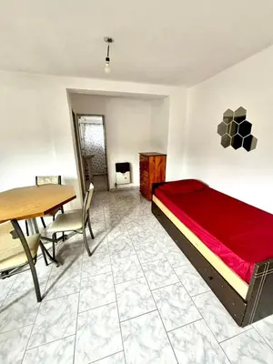 a bedroom with a bed and a table and chairs at alojamiento centrico vcp in Villa Carlos Paz