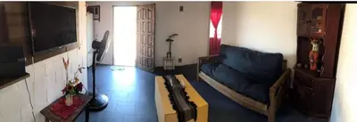 a living room with a blue couch and a table at Turismo CarlosPaz in Villa Carlos Paz