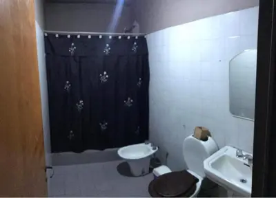 a bathroom with a black shower curtain and a sink at Turismo CarlosPaz in Villa Carlos Paz