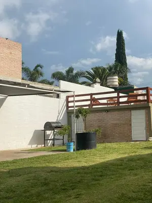 a house with a deck on top of it at Los Jazmines in Alta Gracia