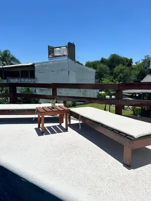 a bench and a table on top of a roof at Los Jazmines in Alta Gracia