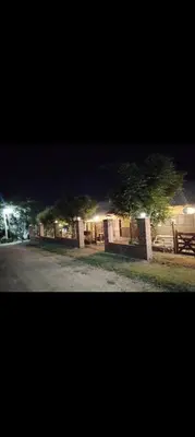 two trees in front of a building at night at Campo Dulce Esperanza in Bialet Massé
