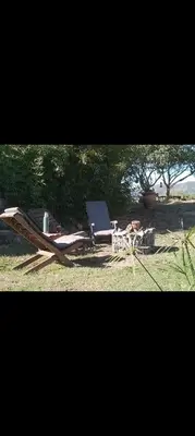 a chaise lounge and a chair in a field at Campo Dulce Esperanza in Bialet Massé