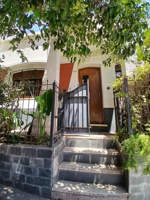 a set of stairs leading to a house with a gate at Casa Corna in Río Cuarto