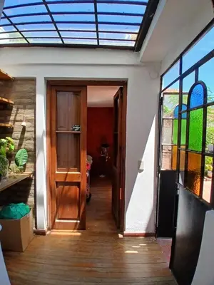 a hallway of a house with a door and a window at Casa Corna in Río Cuarto