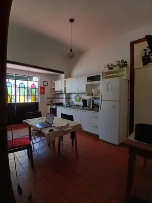 a kitchen with a table and a white refrigerator at Casa Corna in Río Cuarto