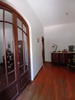 an empty room with a door and a wooden floor at Casa Corna in Río Cuarto